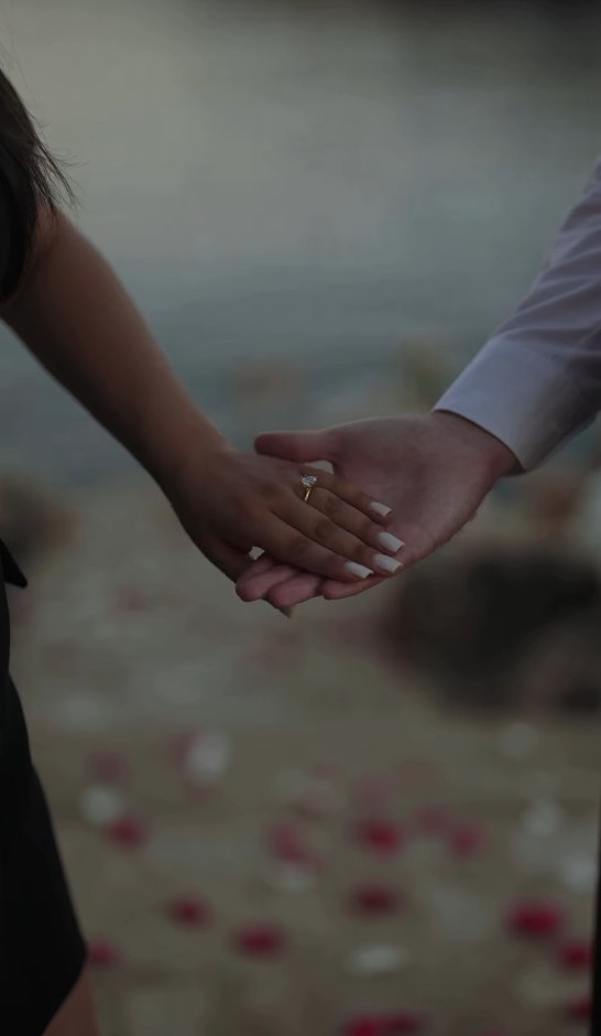 Hand in hand, ring catching the light